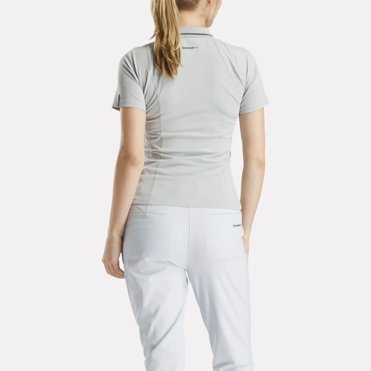 Polo de golf ajusté à manches courtes et fermeture éclair pour femmes Polo de golf ajusté à manches courtes et fermeture éclair pour femmes